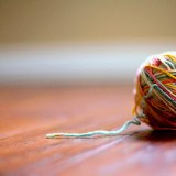 Ball of yarn sitting on a table.