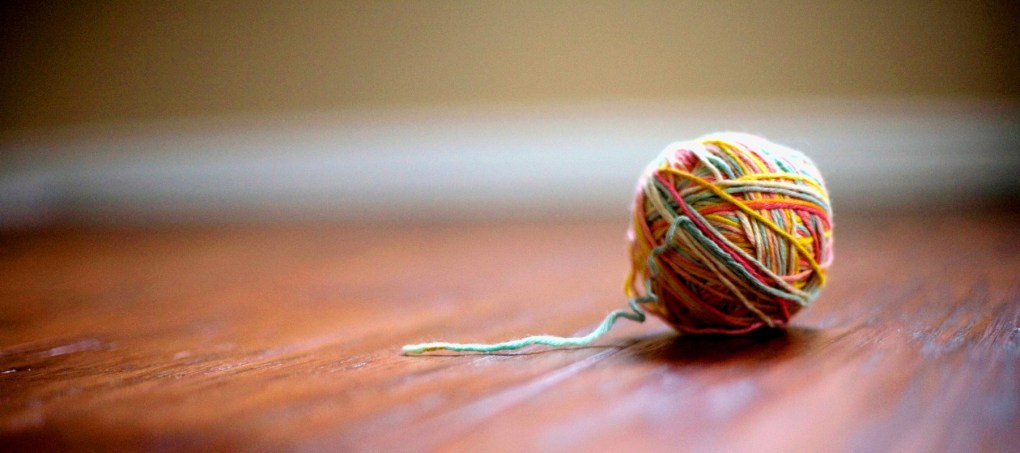 Ball of yarn sitting on a table.