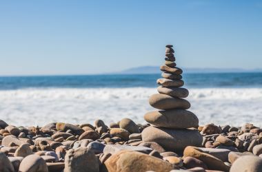 A stack of pebbles, or a rock cairn with an ocean backdrop