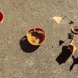 A photo showing three clay pots. The left pot is still intact, the middle pot is starting to break, and the right pot has shattered.