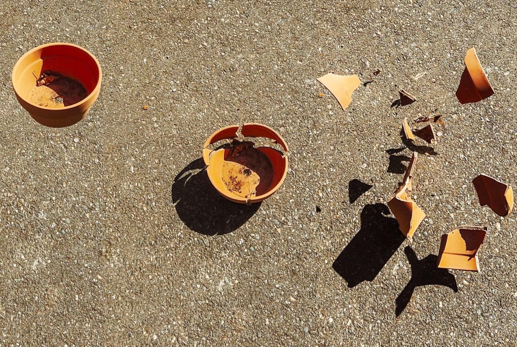 A photo showing three clay pots. The left pot is still intact, the middle pot is starting to break, and the right pot has shattered.